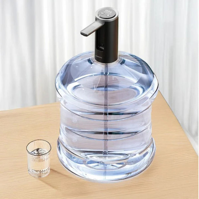 A Porodo Foldable Electric Water Pump is Connected to a Water Can and a Glass is Placed Nearby..