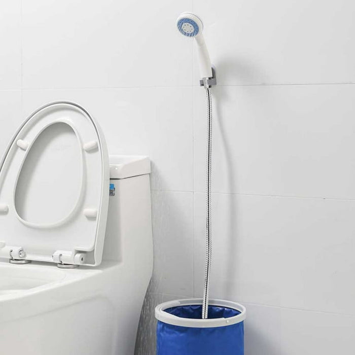 Portable Camping Shower Pump installed on a wall of bathroom near to toilet closet