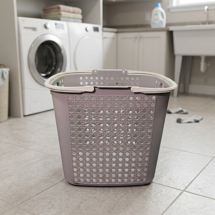 Gray laundry basket on a tiled floor in a laundry room with a washing machine in the background.