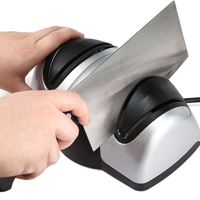 Someone sharpening a knife with the help of a Professional Kitchen Electric Knife Sharpener