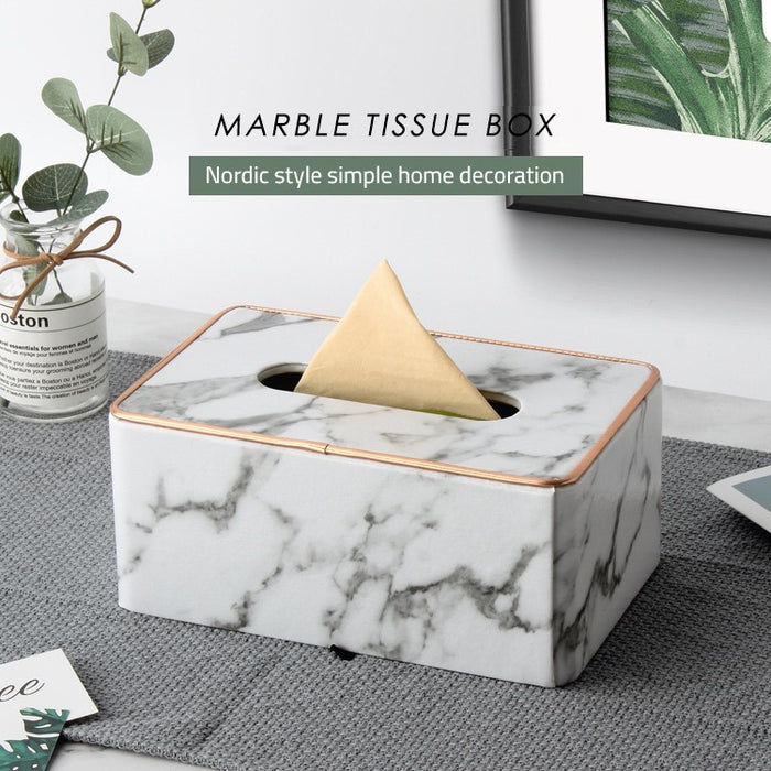 Rectangular Tissue Box Holder placed on a sheet next to a vase of flowers