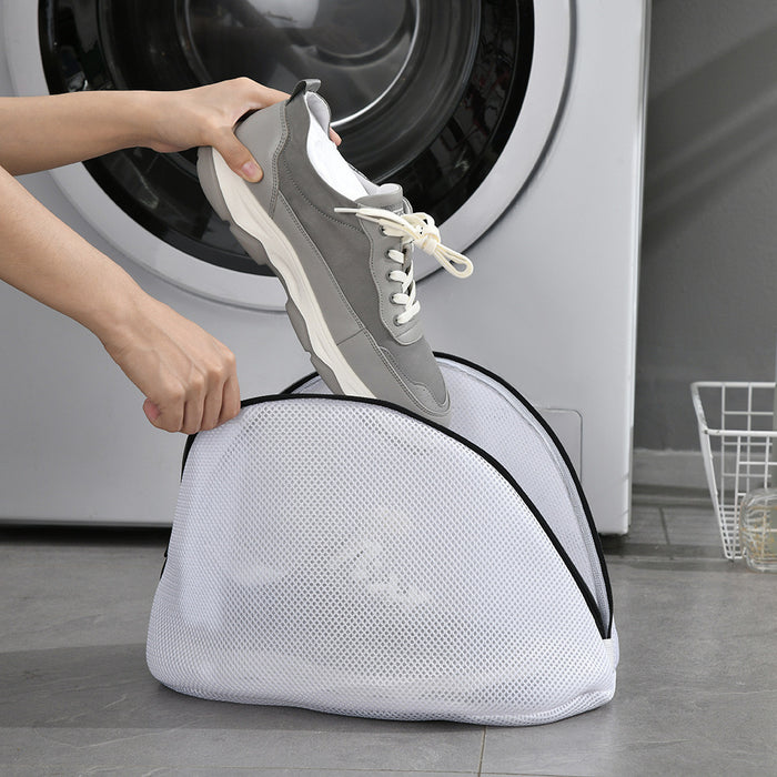 Someone putting shoes into the Reusable Shoes Sneakers Washing Mesh Laundry Bag with Zip Closure