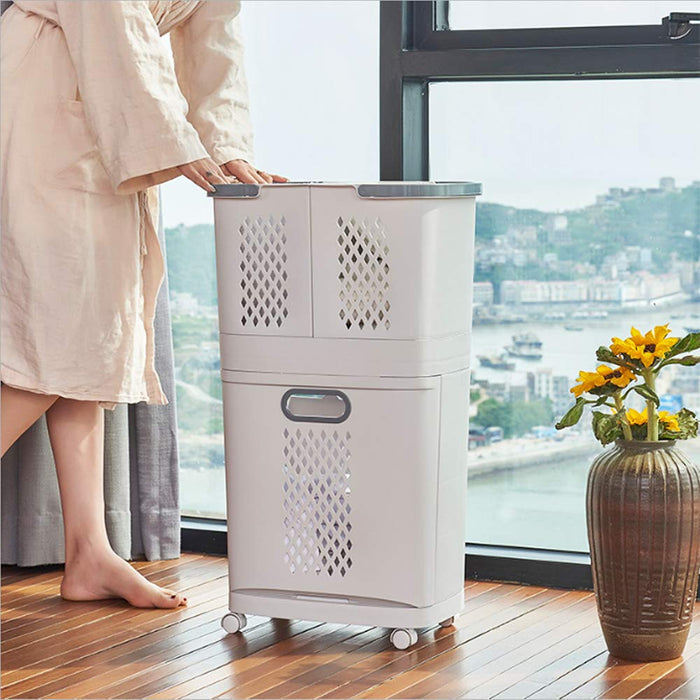 A person standing next to a rolling laundry basket by a window.