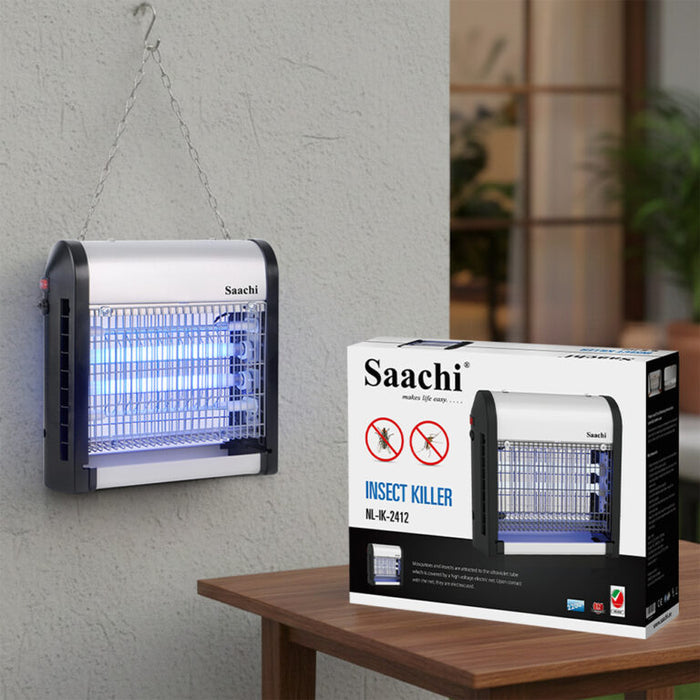 Saachi insect killer on a wall next to its packaging box on a table.