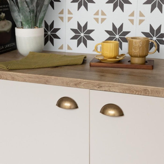 Sand matte vinyl wrapped cupboard with an olive coloured tea towel and a yellow tea cup and milk jug.