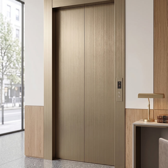 Bronze Metallic vinyl wrapped elevator door in a well-lit hallway with wooden paneling.