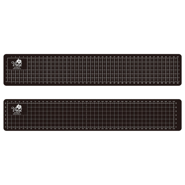 Two black cutting mats with grid lines on a white background