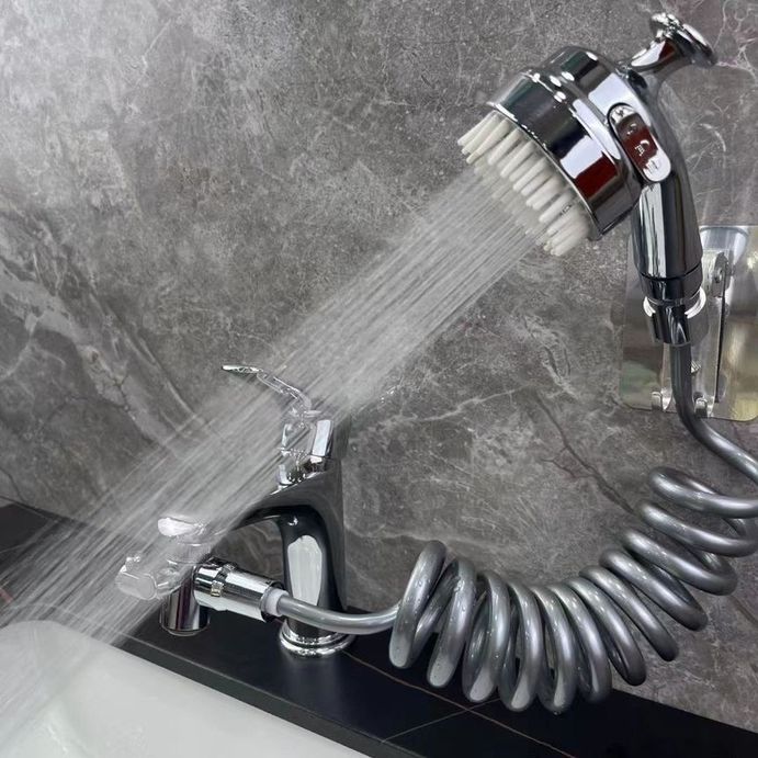 Image displaying the water spraying from a Rotatable Washbasin Faucet Shower which is installed on a wash basin faucet