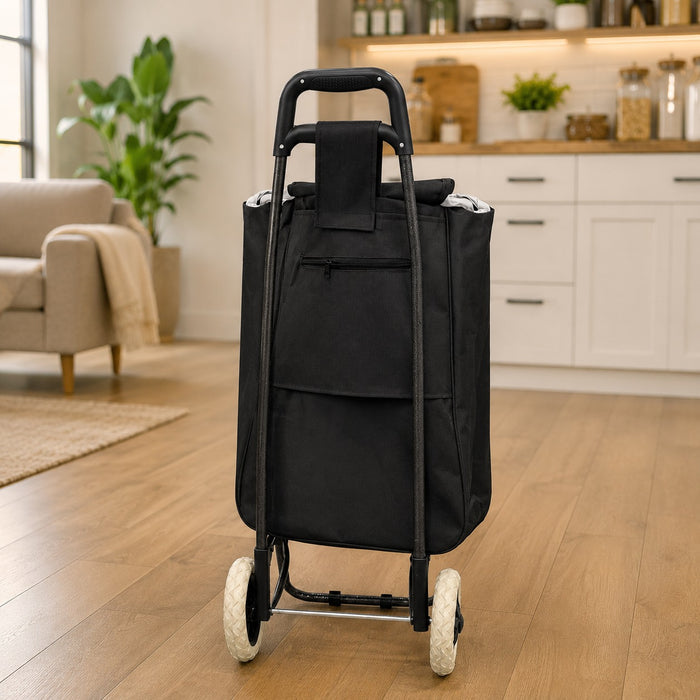 A Foldable Shopping Bag Trolley Cart with a handle and two wheels, shown standing upright in a bright, modern living room and kitchen interior.