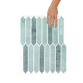 Hexagonal self-adhesive mosaic tiles with a hand holding one tile on a white background
