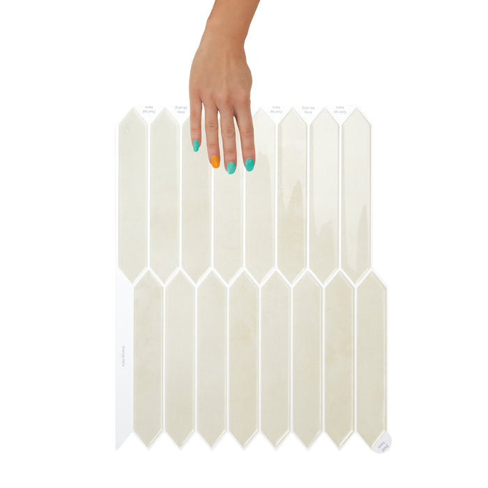 White hexagonal tiles with a hand holding one tile on a white background