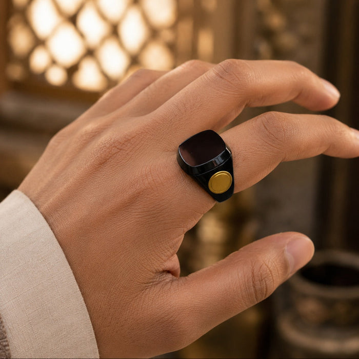 Hand wearing a Smart Tasbih Ring Counter with a blurred warm-toned background