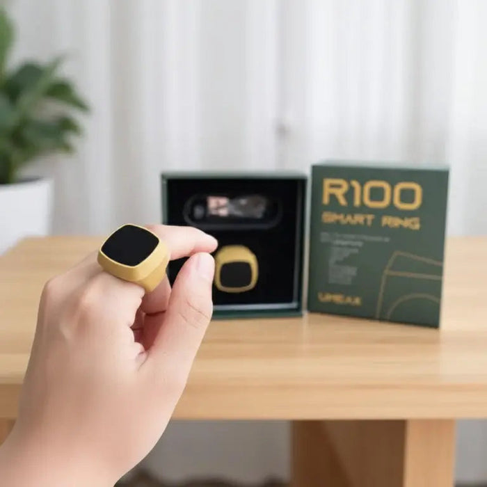 Hand holding a Smart Tasbih Ring Counter with packaging and product description in the background