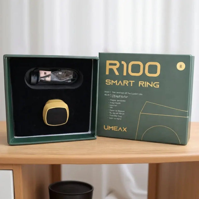 R100 smart ring in UMEAX packaging on a wooden table