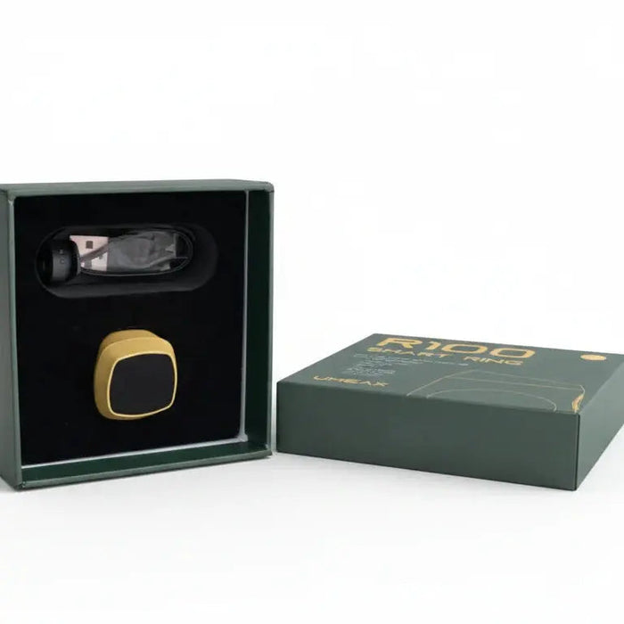 Gold smart ring in a black box with a green box.