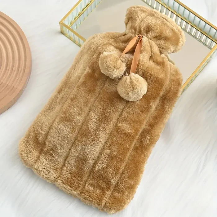 Soft Plush Hot Water Bag with pom-pom handles on a white surface.