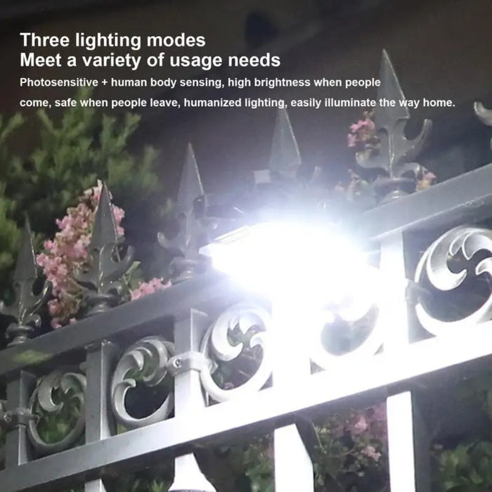 Outdoor solar clip lamp attached to metal fence.