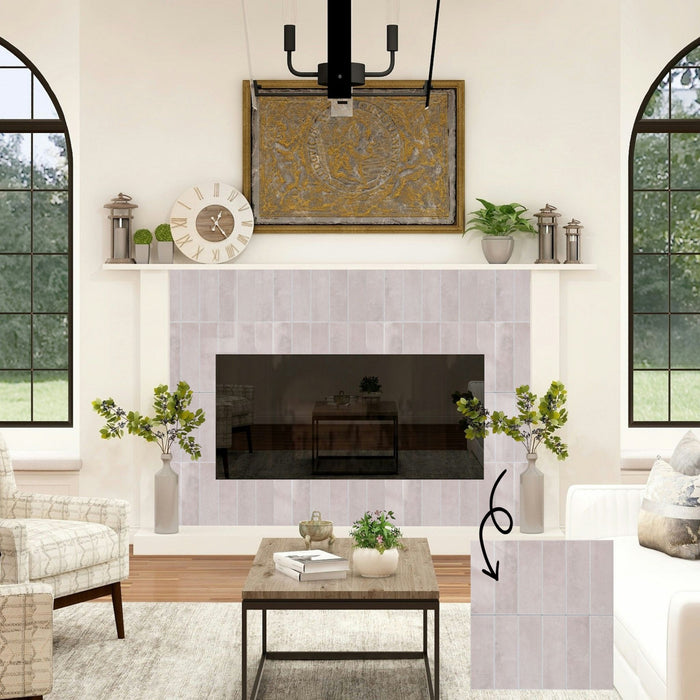 A staged living room interior showing a fireplace with pale blush pink rectangular tiles, plus a floating inset tile sample on the lower right with an arrow pointing to the installed tile area.