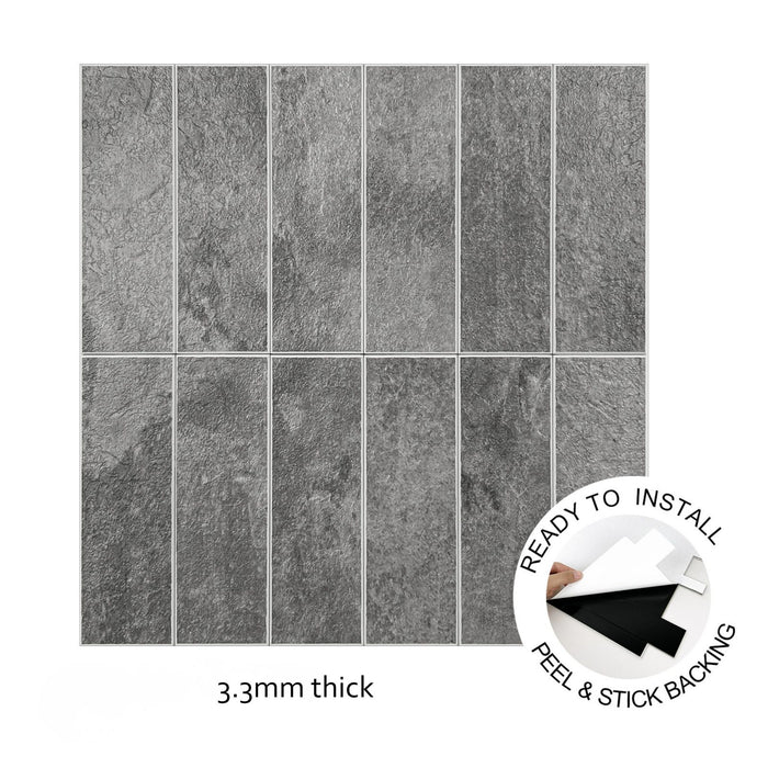 Grey stone-look rectangular wall tiles arranged in a grid, shown with a peel-and-stick backing inset and the text '3.3mm' on a white background.