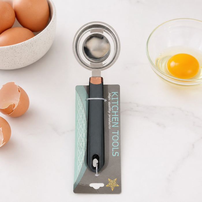 Stainless Steel Egg Yolk Separator is Placed on a Kitchen Countertop along with  a Bowl of Eggs.