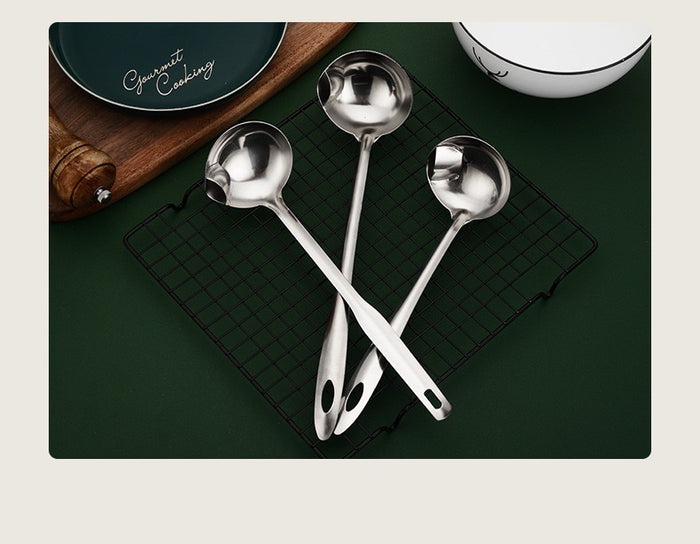 Stainless Steel Oil Separating Skimmer Spoon placed on the net next to kitchen things