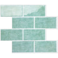 A set of rectangular wall tiles in a watercolor-style mint green and pale sage green finish, arranged in a staggered brick layout on a white background.
