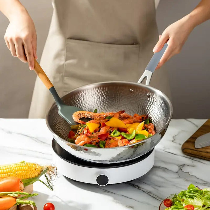 A Person Holding The Wok By Using Multi-Purpose Thermal Insulated Pot Handle Cover.