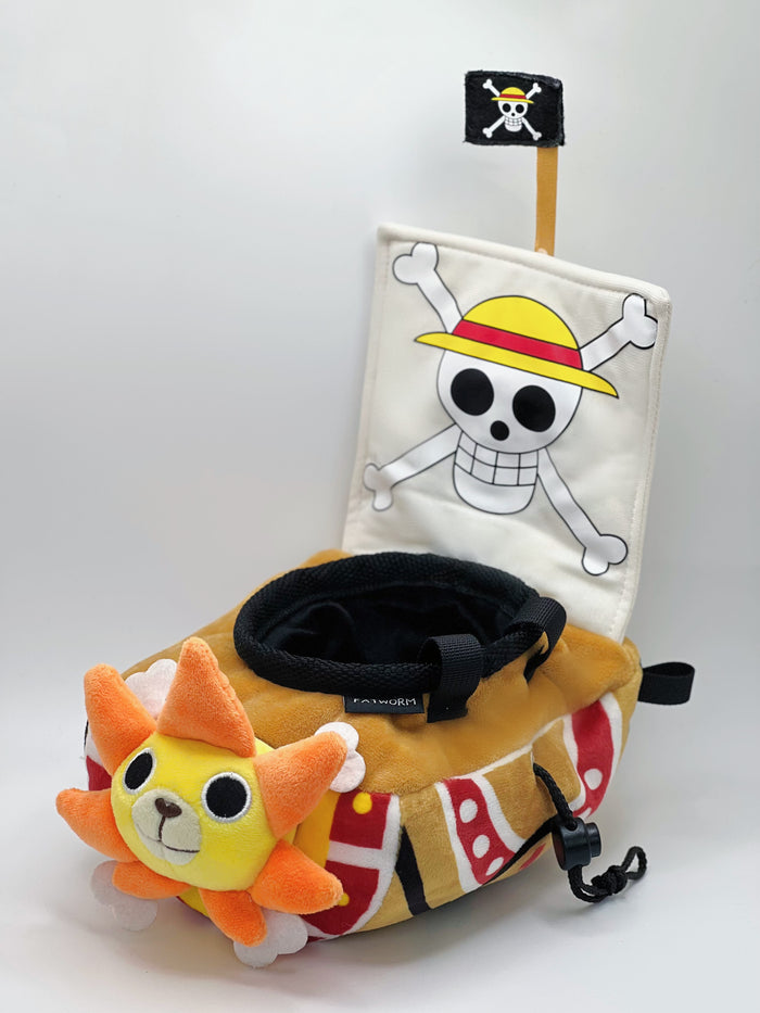 A cute anime plush chalk bag shaped like a famous cartoon pirate ship by Fatworm. This functional lion-headed boat accessory is handmade for bouldering and climbing for rock climbing, featuring a long-durable design that makes a unique climbing gift for any climber.