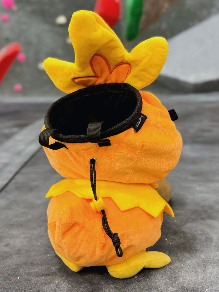 Handmade orange plush Torchic fire chick climbing chalk bag for bouldering. Features yellow feather tufts and a cute bird silhouette. High-quality plush bouldering gift with a 12cm reinforced rim, secure drawstring, and deep black fleece lining for rock climbing.