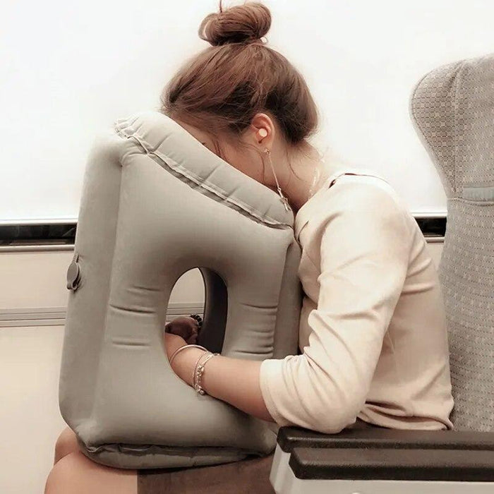 A  woman is Sleeping with the aid of Travel Neck Pillow.