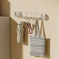 A Wall Mounted Suction Hook Holder is Fixed on a Wall Holding Daily Essentials.