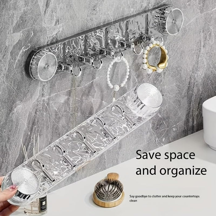 A Wall Mounted Suction Hook Holder is Fixed on a Wall Holding Daily Essentials and a Person is Holding Another One.