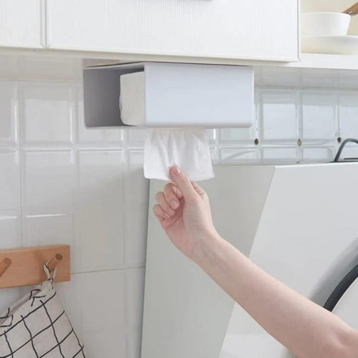A Person is Taking Tissue Kept in a Wall Mounted Tissue Box Holder Dispenser Rack.