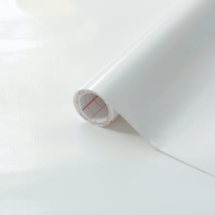 White glossy adhesive vinyl roll on a white background