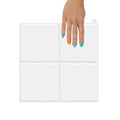 White square zellige wall tiles hold in a hand